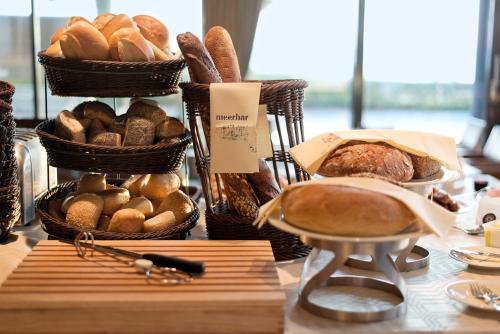 a table topped with a basket filled with bread at Hotel AM MEER & Spa in Binz