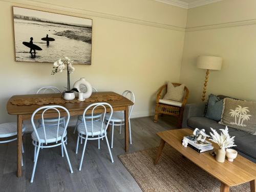 a living room with a table and a couch at Little Manly 3 bedroom Oasis in Sydney