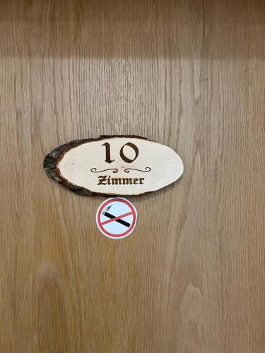 a sign on a wooden door with a skateboard on it at Gasthof Löwen in Pfronten