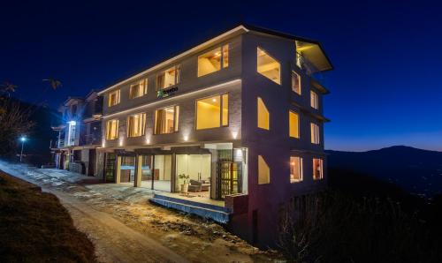 a building at night with the lights on at Treebo Trend The Northern Retreat Resort With Mountain View in Shimla