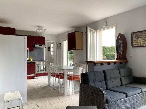 un salon et une cuisine avec un canapé et une table dans l'établissement Maison à Trébeurden : Jardin, Terrasse, WIFI, Parking, 3 Chambres, Plages et Commerces à Proximité - FR-1-368-402, à Trébeurden