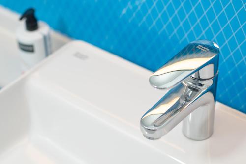 a bathroom sink with a chrome faucet on a sink at Holiday Inn Express Weifang City Center by IHG in Weifang
