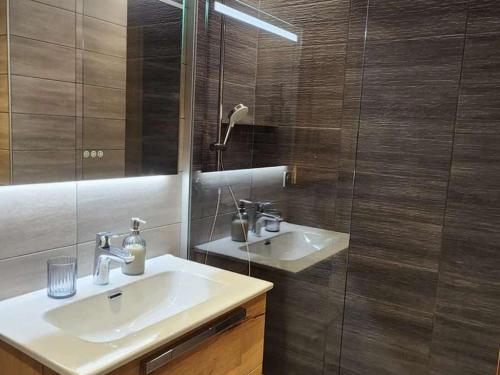 a bathroom with a sink and a glass shower at Appartement rénové Les Gets, 4 pers., balcon, parking, navette gratuite - FR-1-623-354 in Saint Pierre en Faucigny