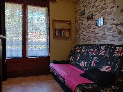a living room with a couch and a brick wall at Studio Bourg-Saint-Maurice, 1 pièce, 3 personnes - FR-1-411-920 in Bourg-Saint-Maurice