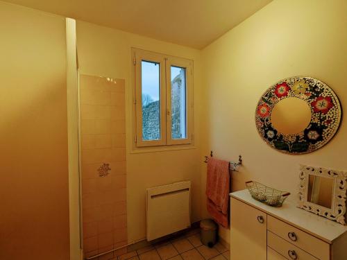 a bathroom with a shower and a mirror on the wall at Charmant gîte avec terrasse, poêle à bois et parking privé près de la Creuse et d'Argenton-sur-Creuse - FR-1-591-564 in Le Menoux
