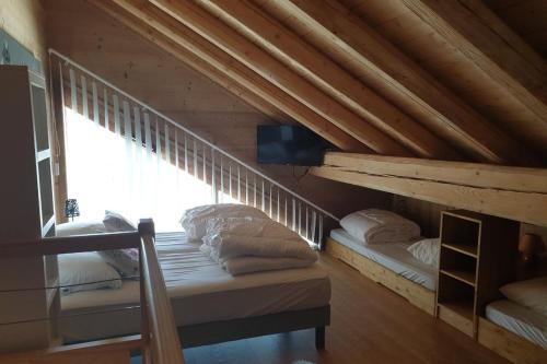 a room with two bunk beds in a attic at LOdyssée 203 in La Toussuire