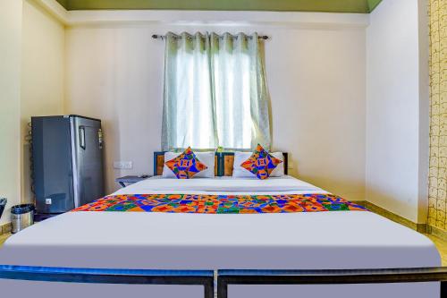 a large bed in a room with a window at FabHotel Bungalow 18 in Jaipur