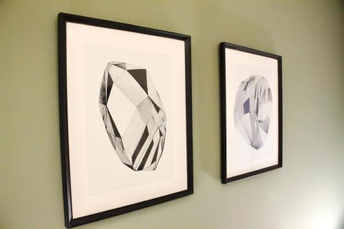 two framed pictures of ties hanging on a wall at Wolf House BnB in Coppito