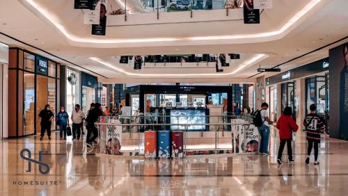 a group of people walking in a shopping mall at Homesuite' Home at The Loft in Kota Kinabalu