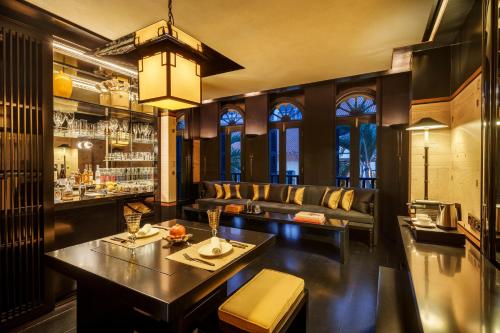 a bar with a couch and a table at Duxton Reserve Singapore, Autograph Collection in Singapore