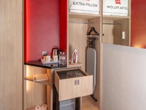 a small kitchen with a sink and a refrigerator at ibis Kuala Lumpur City Centre in Kuala Lumpur