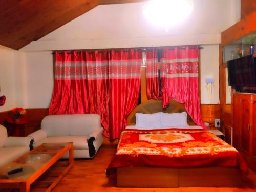 a bedroom with a bed and red curtains at Shyam Cottage, Manali-With Kitchen in Manāli