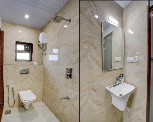 a bathroom with a shower and a toilet and a sink at Kiwi International,Hotel,Mumbai in Mumbai