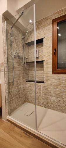 a shower with a glass door in a bathroom at Affittacamere Le Vele in Genoa