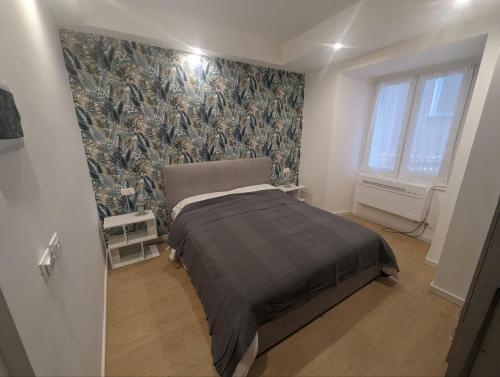 a bedroom with a bed and a wall mural at Affittacamere Le Vele in Genoa