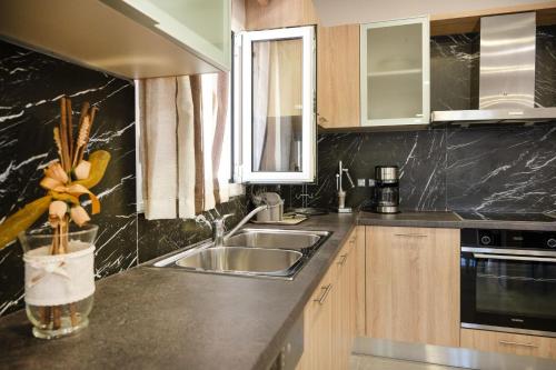 a kitchen with a sink and a counter top at Villa Iskander in Roda