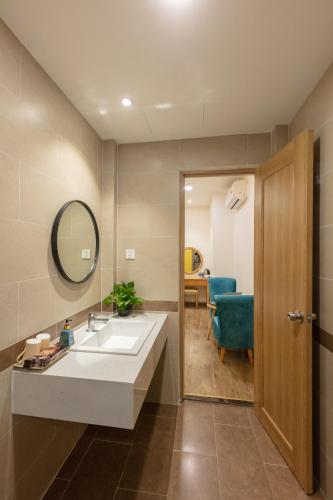 a bathroom with a sink and a mirror at Đại Nam SG Hotel in Ho Chi Minh City