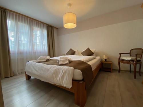 a bedroom with a large bed and a large window at Chalet Pfingsteggblick in Grindelwald