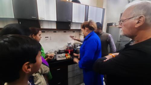 a group of people standing in a kitchen at Vedic Life Homestay & Wellness Centre in Jaipur