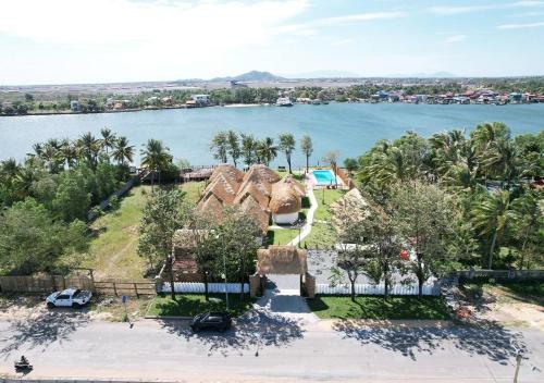 an aerial view of a house with a lake at SEA SAND RESORT in Kampot