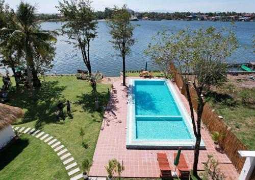 an overhead view of a swimming pool next to the water at SEA SAND RESORT in Kampot