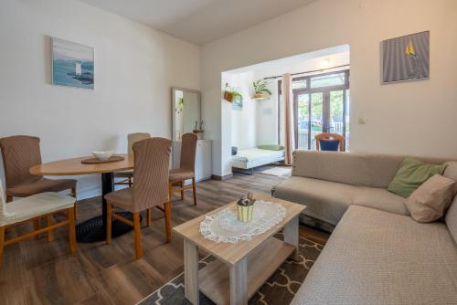 a living room with a couch and a table at Apartment Dom in Jadranovo