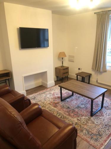 a living room with a couch and a coffee table at Beautiful Riverside cottage in March