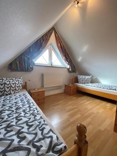 a attic room with a bed and a window at Fehmarn 17-6 in Fehmarn