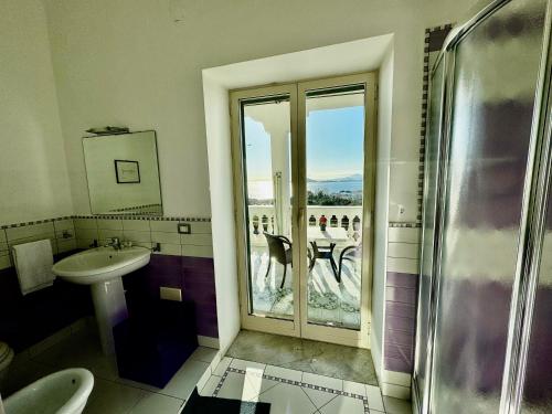 a bathroom with a shower and a sink and a window at B&B Dumbolo in Pozzuoli