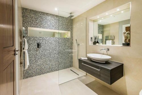 a bathroom with a sink and a shower at Modern & Private Belgravia Apartment - Sleeps 4 in London