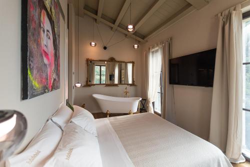 Schlafzimmer mit einem Bett und einer Badewanne in der Unterkunft Tenuta Zamparina in Montignoso