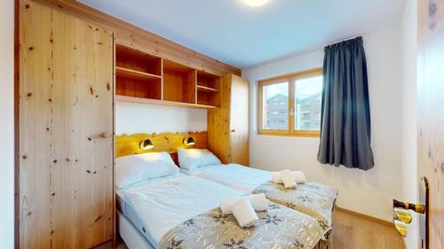 a bedroom with a large white bed and a window at Pracondu 1 301 - OUTDOOR & FUN apartment 6 pers in Nendaz