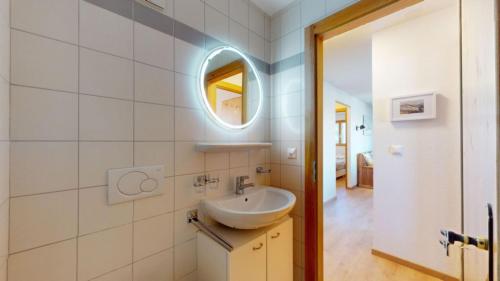a bathroom with a sink and a mirror at Pracondu 1 301 - OUTDOOR & FUN apartment 6 pers in Nendaz