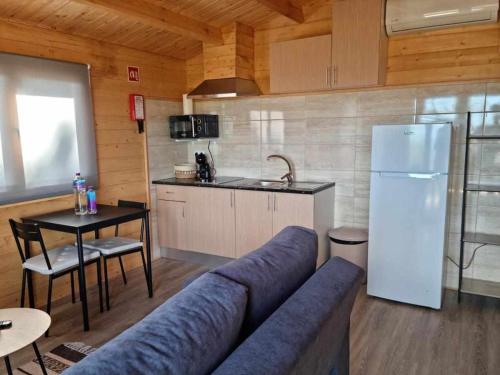 a living room with a blue couch in a kitchen at Quinta da Idalina in Monchique