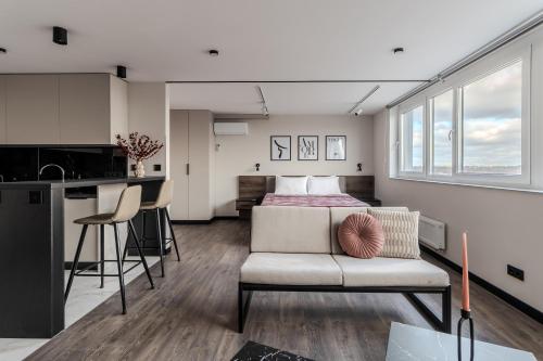 a bedroom with a bed and a couch in a room at 77 views apartments by INSHI in Lviv