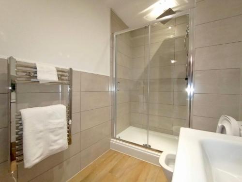 a bathroom with a shower and a sink at Luxury 2 Bed 2 Bath Flat Near Old Trafford in Manchester