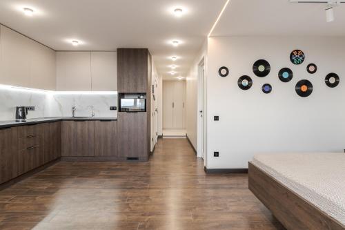 a kitchen and living room with a bed in a room at 77 views apartments by INSHI in Lviv