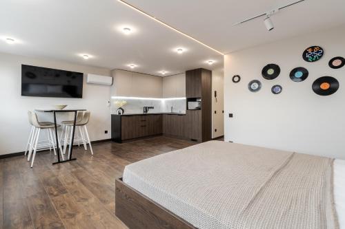 a bedroom with a bed and a table with chairs at 77 views apartments by INSHI in Lviv