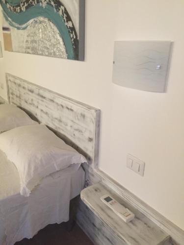 a bedroom with a bed and a picture on the wall at Aquila Di Mare in Fiumicino