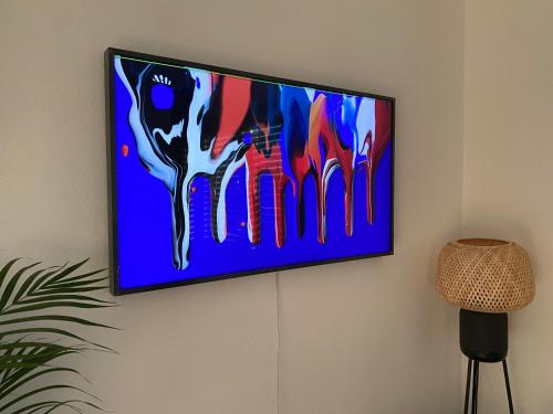 a flat screen tv hanging on a wall at Design-Apartment in Langenbach