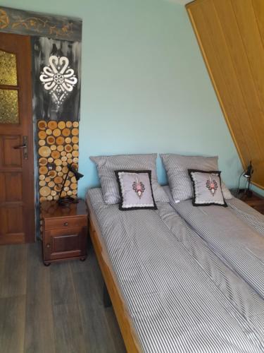 a bedroom with two beds with pillows on it at Apartamenty Wierch 17 in Kościelisko