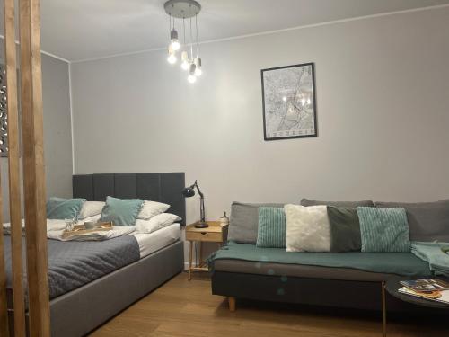 a living room with a couch and a table at Yellow Stone Apartment in Szczecin