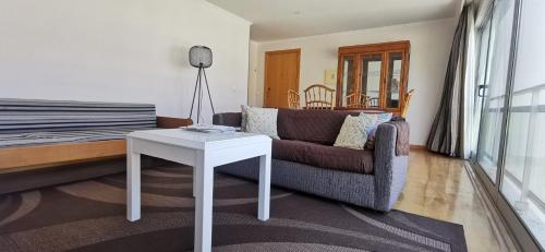 a living room with a couch and a table at Welcome Buddy - Santo Amaro Apartment in Vila Franca do Campo