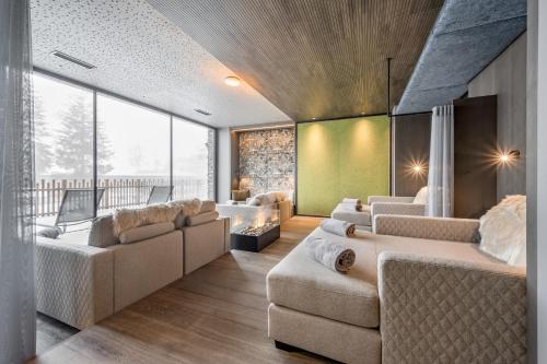 a living room with couches and a large window at Summit Seefeld in Seefeld in Tirol