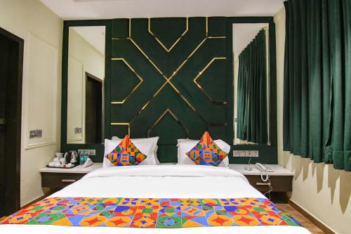 a bedroom with a large bed with a colorful blanket at FabHotel Prime K9 Crown in Ludhiana