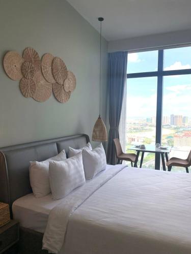 a bedroom with a bed with a view of a patio at ZX Service Apartment in Phnom Penh