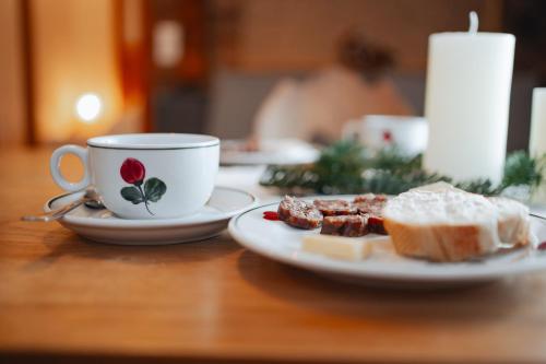 a table with a cup of coffee and a plate of food at Hörandlhof in Aigen im Ennstal