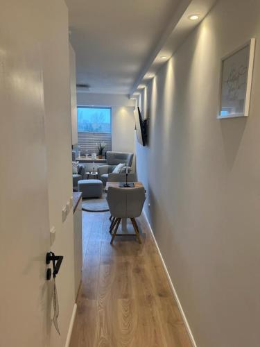 a hallway with a living room with a couch and a table at Schleibude in Schleswig