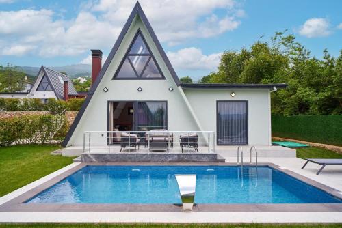 a house with a swimming pool in front of a house at Timeless Kartepe in Kartepe