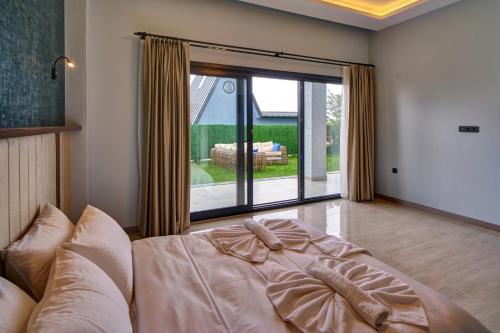 a bedroom with a bed and a large window at Timeless Kartepe in Kartepe
